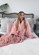 WARM BUDDY - Cozy Ultra Plush Spa Robe in Pink, Shown on a women on a bedroom setting