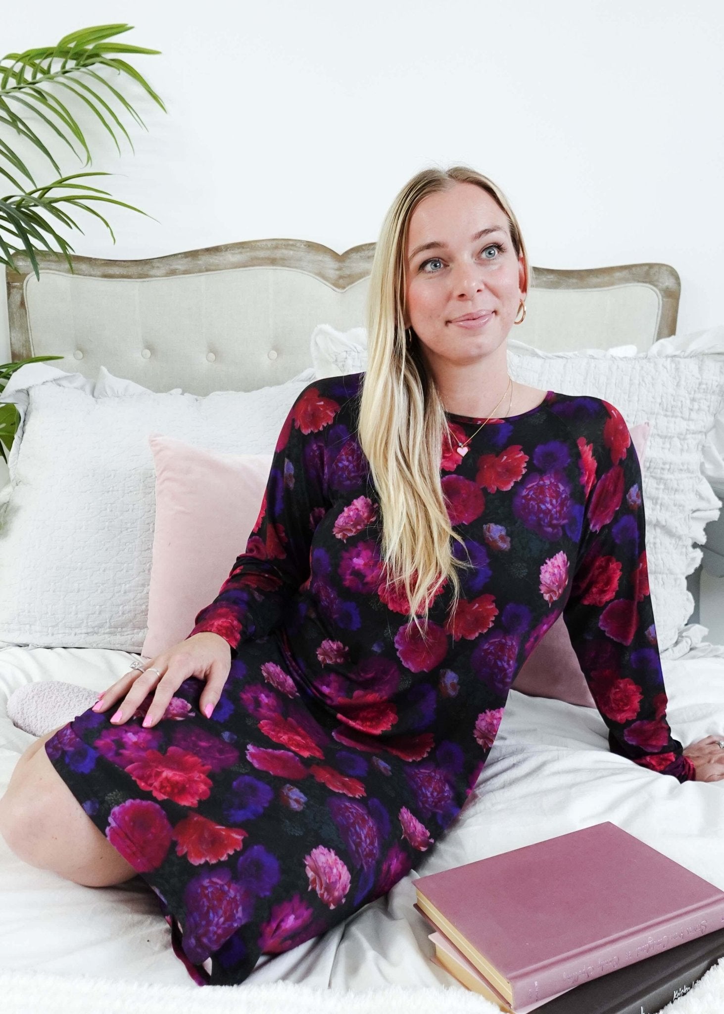 Winter Blossom Long Sleeve Bamboo Nightshirt | GEORGIA RYLAN. Model Robyn sits on a plush bed with a book in the nightgown. 