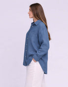 Yoga Jeans Elena Linen Oversized Button Up Top in soft blue, showcasing a side view with relaxed fit and stylish buttons.