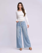 Yoga Jeans LILY Wide Leg Drawstring Jeans in Rihanna Wash, styled with a fitted long-sleeve top.