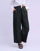 YOGA JEANS Sofia Linen Wide Leg Pant showcased on model wearing a white shirt and sandals.