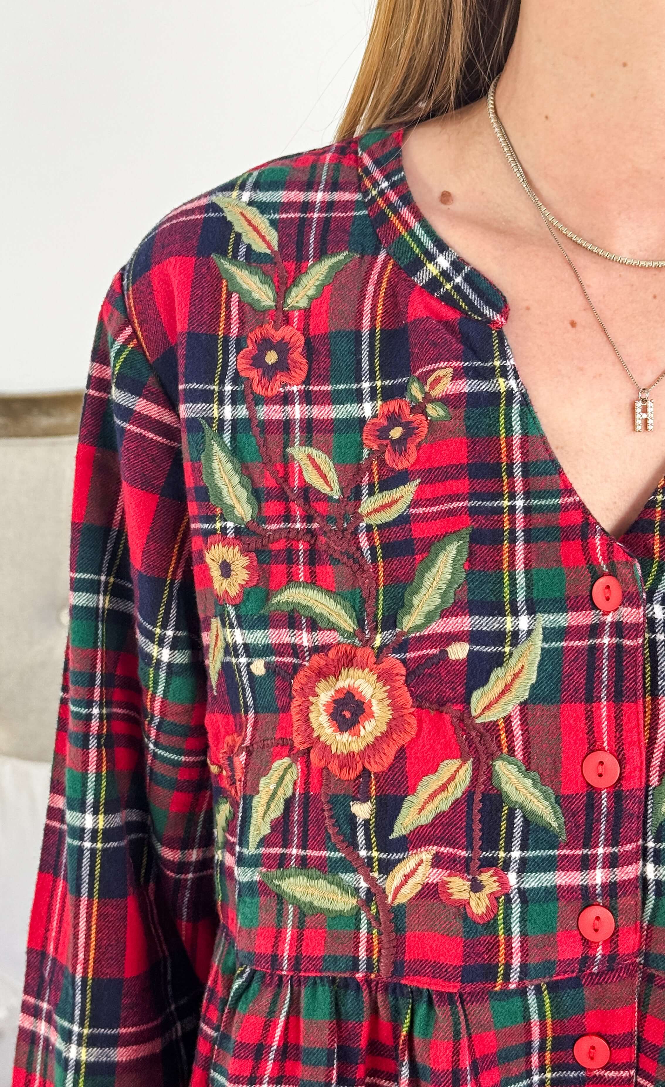 Close-up of Yuletide Check Long Flannel Nighty featuring floral embroidery in red plaid pattern by April Cornell.