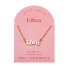 Zodiac Script Necklace in 14K Plated Gold featuring the astrological sign Libra on a pink card by Foxy Originals.